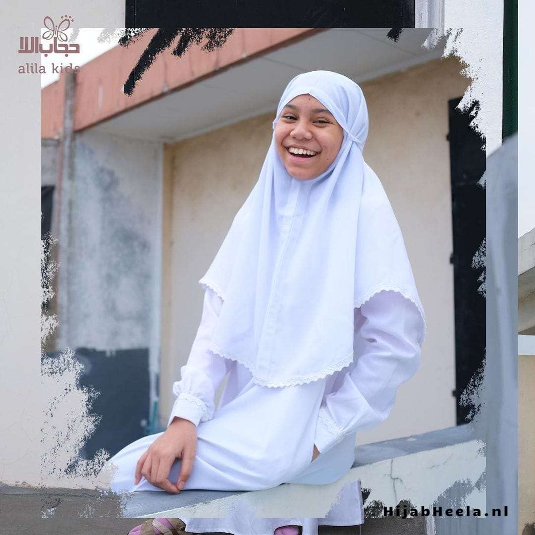 a man in a white shirt holding a skateboard