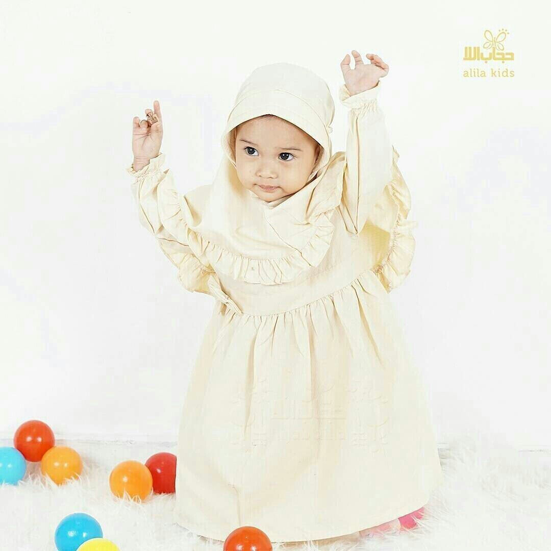 a woman in a white dress holding a pair of scissors